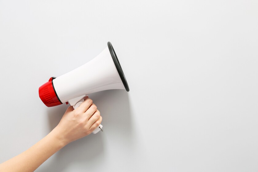 Female hand with megaphone on white background