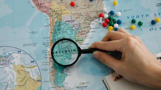 Magnifying glass focusing on a map of South America.jpg