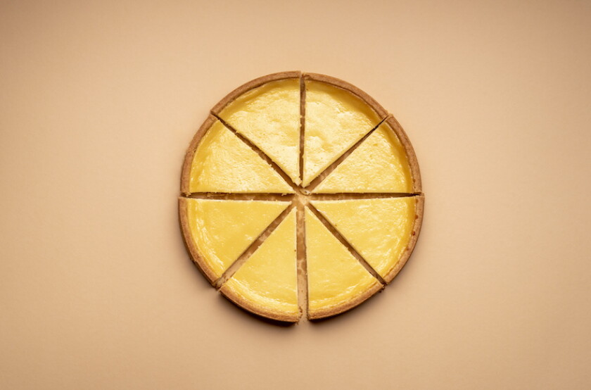 Sliced cheesecake on a yellow background. Equal sliced cake