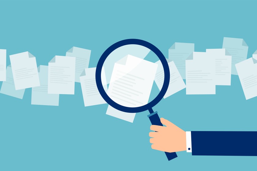 Employer with magnifying glass exploring application papers