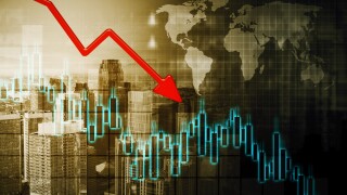 Declining arrow and candlestick with world map