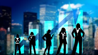 Women silhouetted against a city skyline