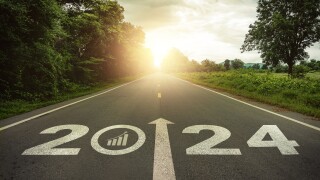 2024 Goal plan action, Business target and growth strategy. Business annual plan and development for achieving goals and success. 2024 written on the road in the middle of asphalt road with at sunset.