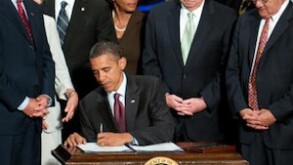 US President Barack Obama signs the Dodd