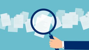 Employer with magnifying glass exploring application papers