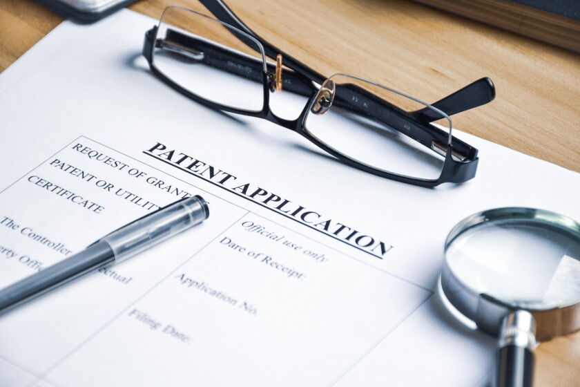 Patent Application form on desk for publication for invention. Selective focus.