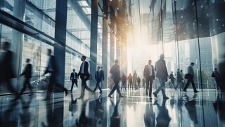 Blurred group of busy business people moving through a corporate office space