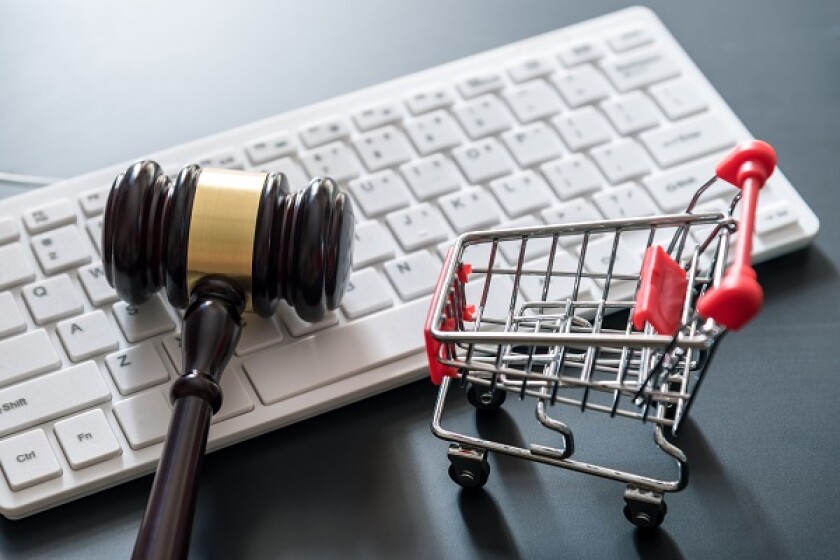 computer keyboard , shopping cart and auction hammer on  black  background , online shopping concept