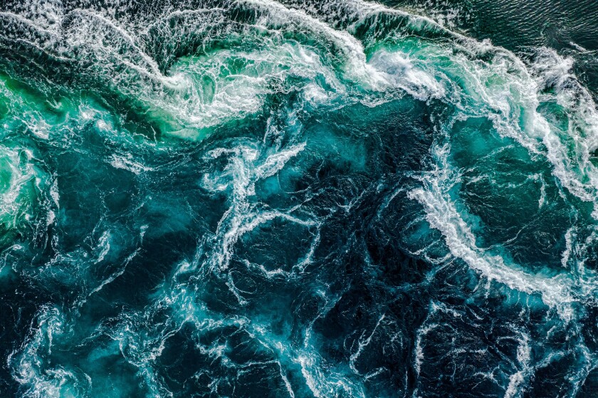 Abstract background. Waves of water of the river and the sea mee