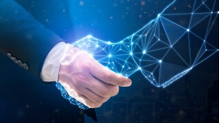 Businessperson shaking hand with digital partner over futuristic
