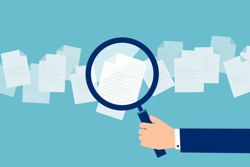 Employer with magnifying glass exploring application papers