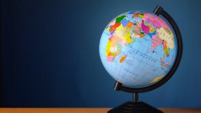 globe on a table against the wall of blue