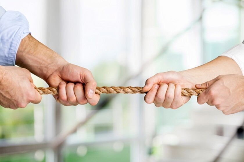 Tug war, two businessman pulling a rope in opposite directions isolated on white background