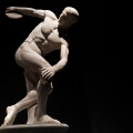 Discus thrower discobolo statue isolated on black