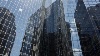 Panoramic and perspective wide angle view to steel light blue background of glass high rise building skyscraper commercial modern city of future. Business concept of successful industrial architecture