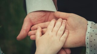 Child's hand in palm of relatives.jpg