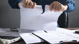 Businessman breaking contract at office.