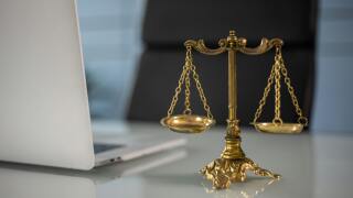 Scales of justice by a laptop