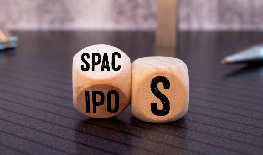 SPACs vs IPOs symbol. Cubes with words 'SPACs, special purpose acquisition companies' and 'IPOs