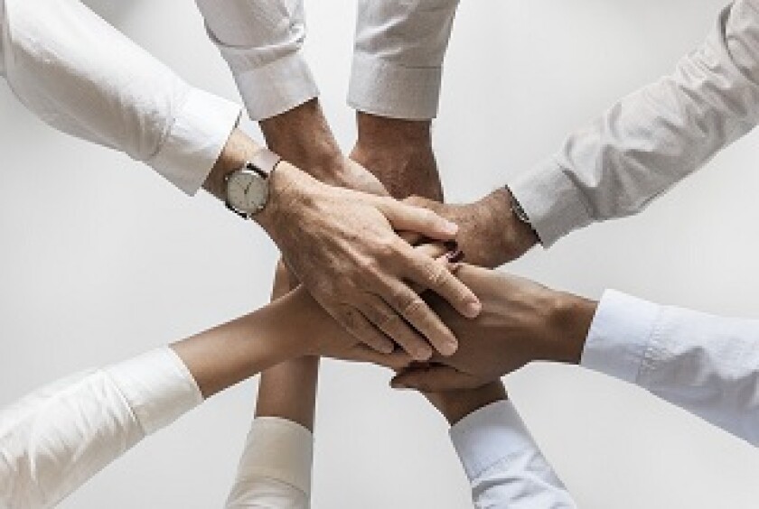 Group of people holding hands in a circle