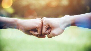 Hands of two man people fist bump team teamwork and partnership business success. Volunteer charity work. People joining for cooperation mergers and acquisitions concept