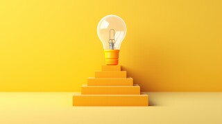 light bulb on top of ladder on yellow background