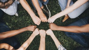Diverse people doing a fist bump in the park