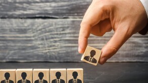 The leader builds team from cubes with employees. Businessman in search of new employees and specialists. personnel selection and management within the team. removes / dismisses the employee