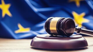 Judges wooden gavel with EU flag in the background. Symbol for jurisdiction