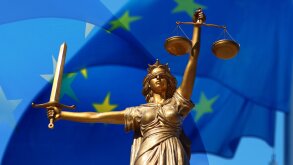 Lady of Justice against backdrop of EU flag