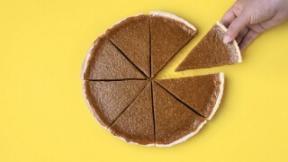 Sliced pumpkin pie. Taking a pie slice.