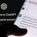 ChatGPT chat bot screen seen on smartphone and laptop display wi