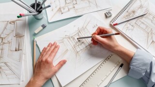 Interior designer making hand drawing pencil sketch of a bathroom