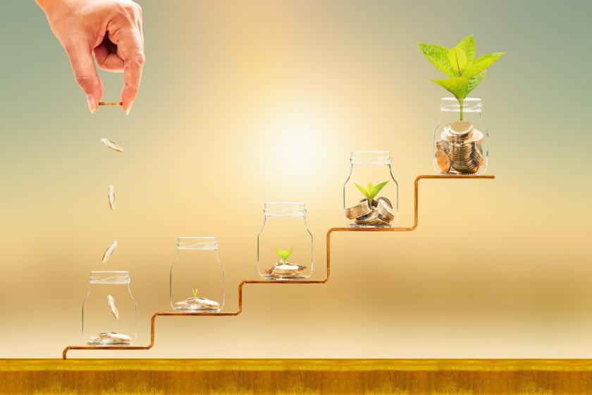 Investor hand hold and drop a gold coin in the five bottle and p