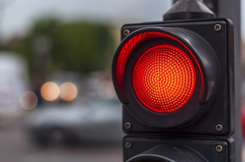 Red traffic light in the city street