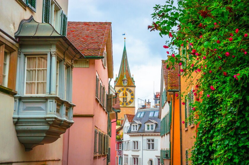 Beautiful cozy street and tower of Saint Peter church in the city center of Zurich, Switzerland