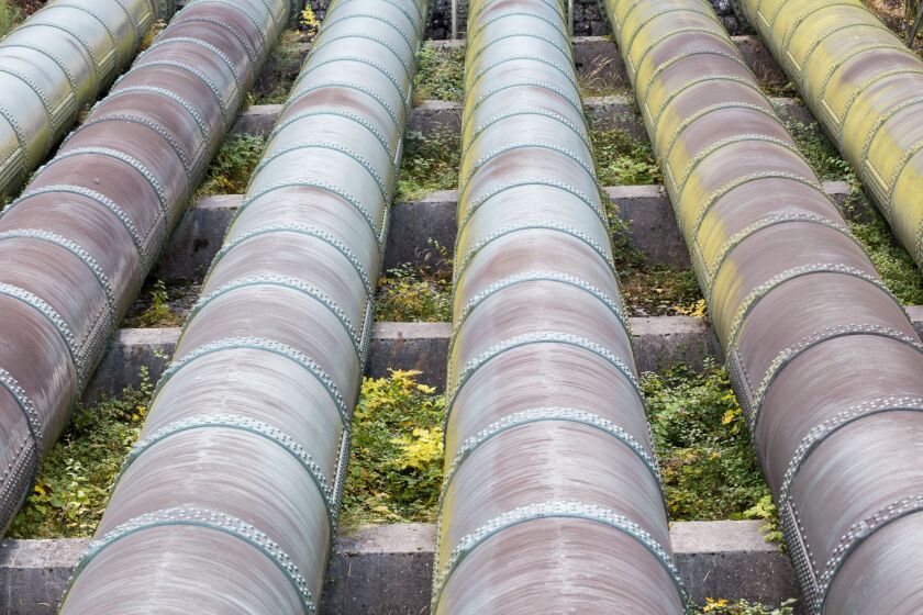 Close-up of water pipes of an hydro electric power plant. Symbol for environment-friendly electricity and power generation.