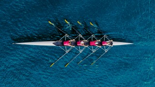 Women's rowing team on blue water