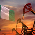 Nigeria oil industry concept. Industrial illustration - Nigeria flag and oil wells with the red and blue sunset or sunrise sky background - 3D illustration