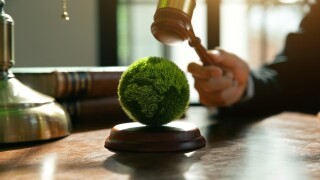 Hand of jude is hitting on earth with wooden gavel, Environmental law and international agreement about protocol for framework convention on climate change, world and environment sustainable conservat