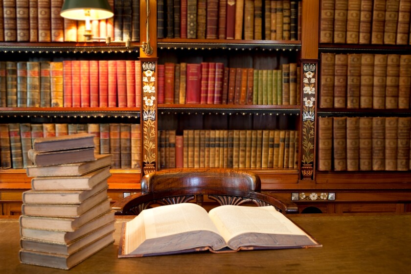 Old classic library with books on table