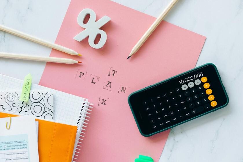 Calculator, pencils, and paper with "tax plan" on it