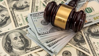 dollar money and judges gavel on table