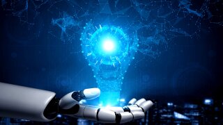 Robotic hand holding digital lightbulb with network connections