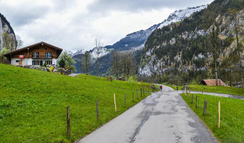 Road leading to Swiss mountain and chalet