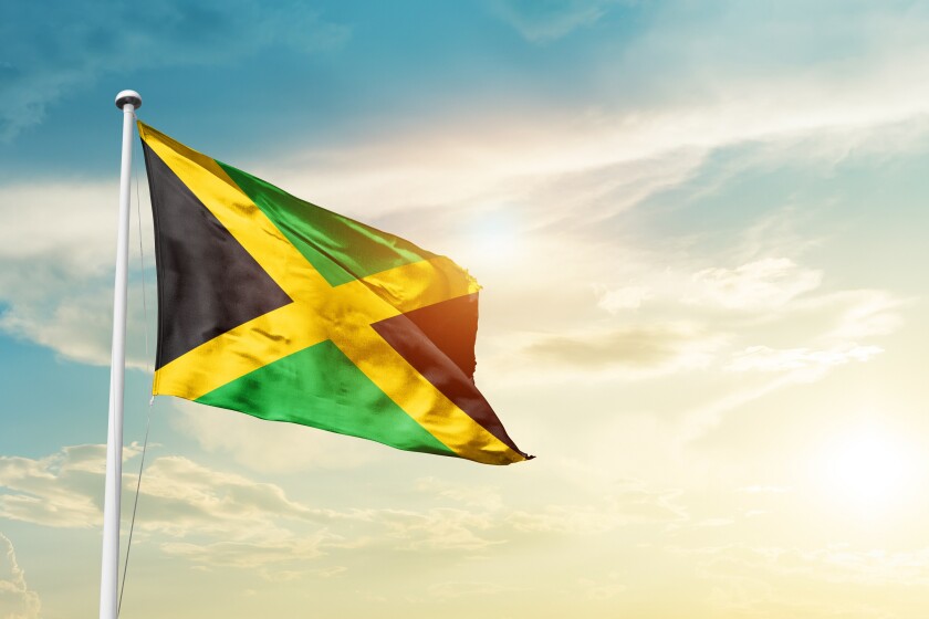 Jamaica national flag cloth fabric waving on the sky - Image
