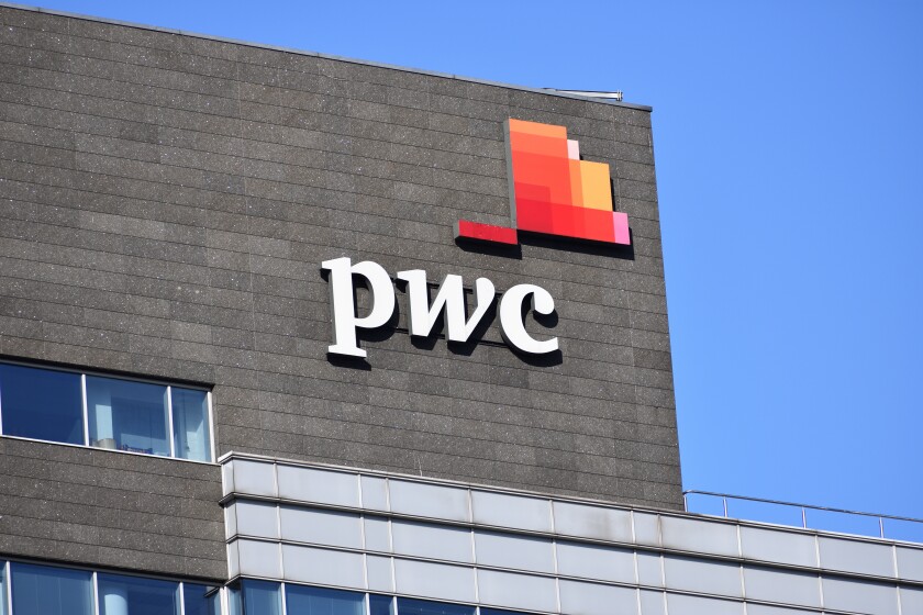 PWC PricewaterhouseCoopers logo, signage on the facade, audit and assurance, consulting and tax services company. WARSAW, POLAND - FEBRUARY 12, 2022