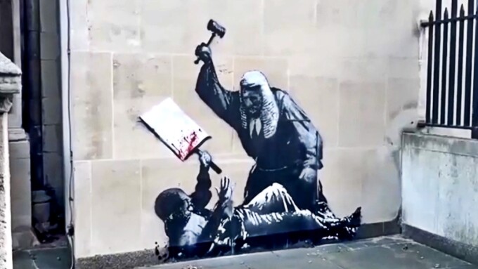 British_street_artist_Banksy_has_painted_a_mural_on_London's_High_Court_depicting_a_judge_beating_a_protester.jpg