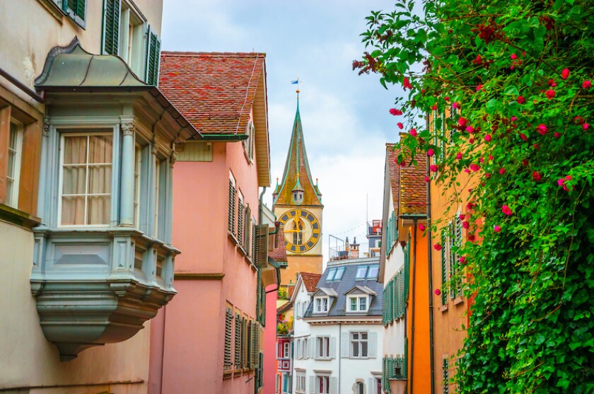 Beautiful cozy street and tower of Saint Peter church in the city center of Zurich, Switzerland