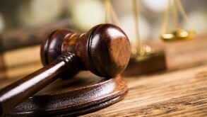 Golden scales of justice, books, Statue of Lady Justice. Owl and